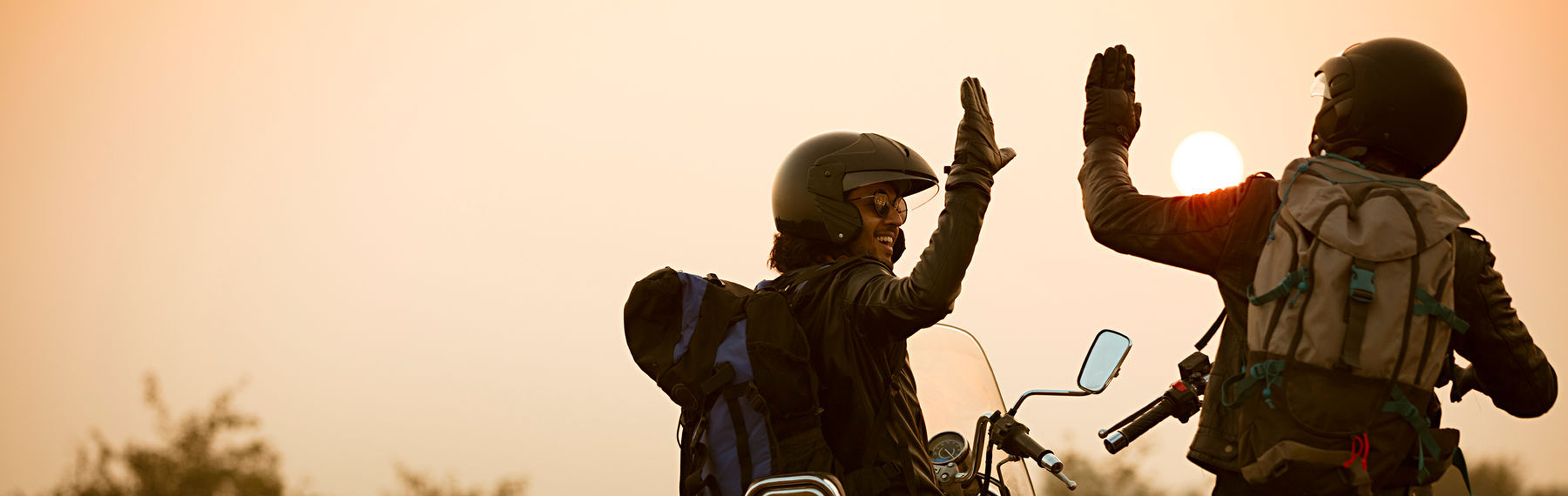 Motorcyclists high-fiving